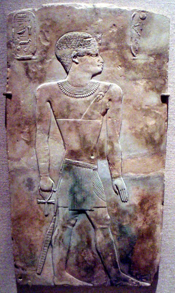 Libyan ruler of Ancient Egypt name Iuput II. Limestone engraving of full body. Two cartouches on either side of the body. Image source is the Brooklyn Museum. Iuput II's phenotype is of a Black man with short, coarse hair, a full nose, and full lips.